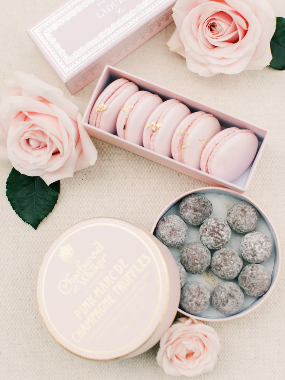 Wedding day treats of light pink macaroons and champagne chocolates