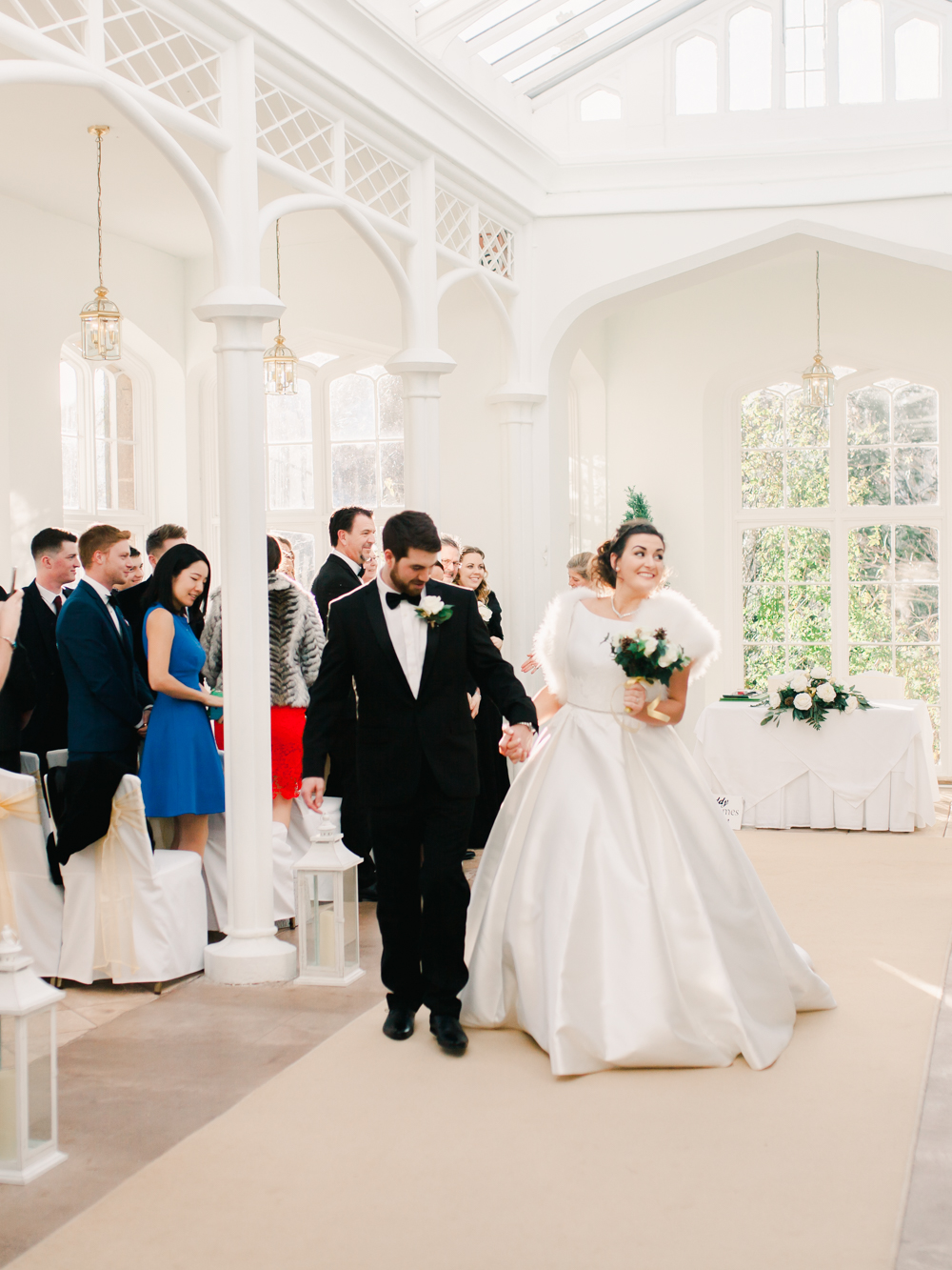 Bride and Groom walk out of the orangery 