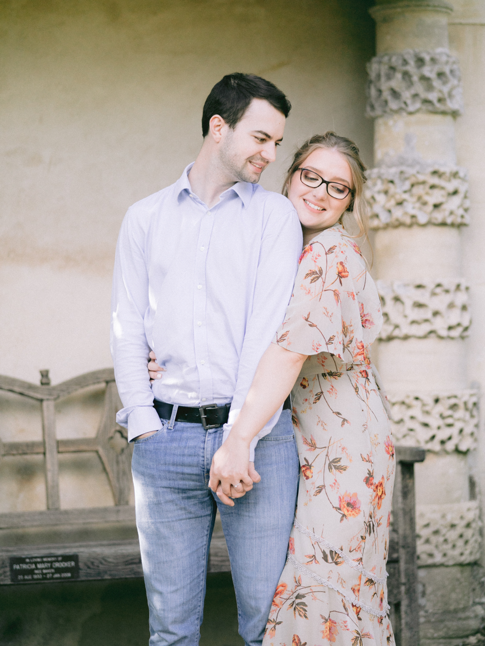 Romantic Couple giggle and hold hands during their engagement session at Painswick Rococo Garden
