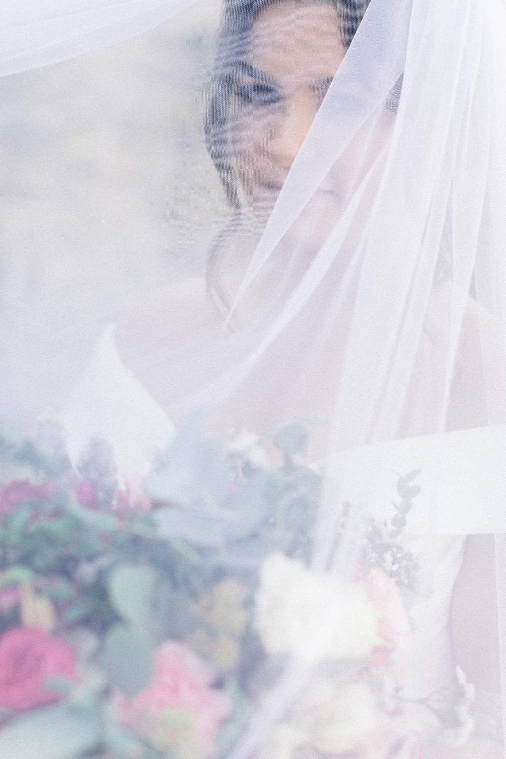 Bride portrait with elegant veil over her face before the wedding ceremony starts