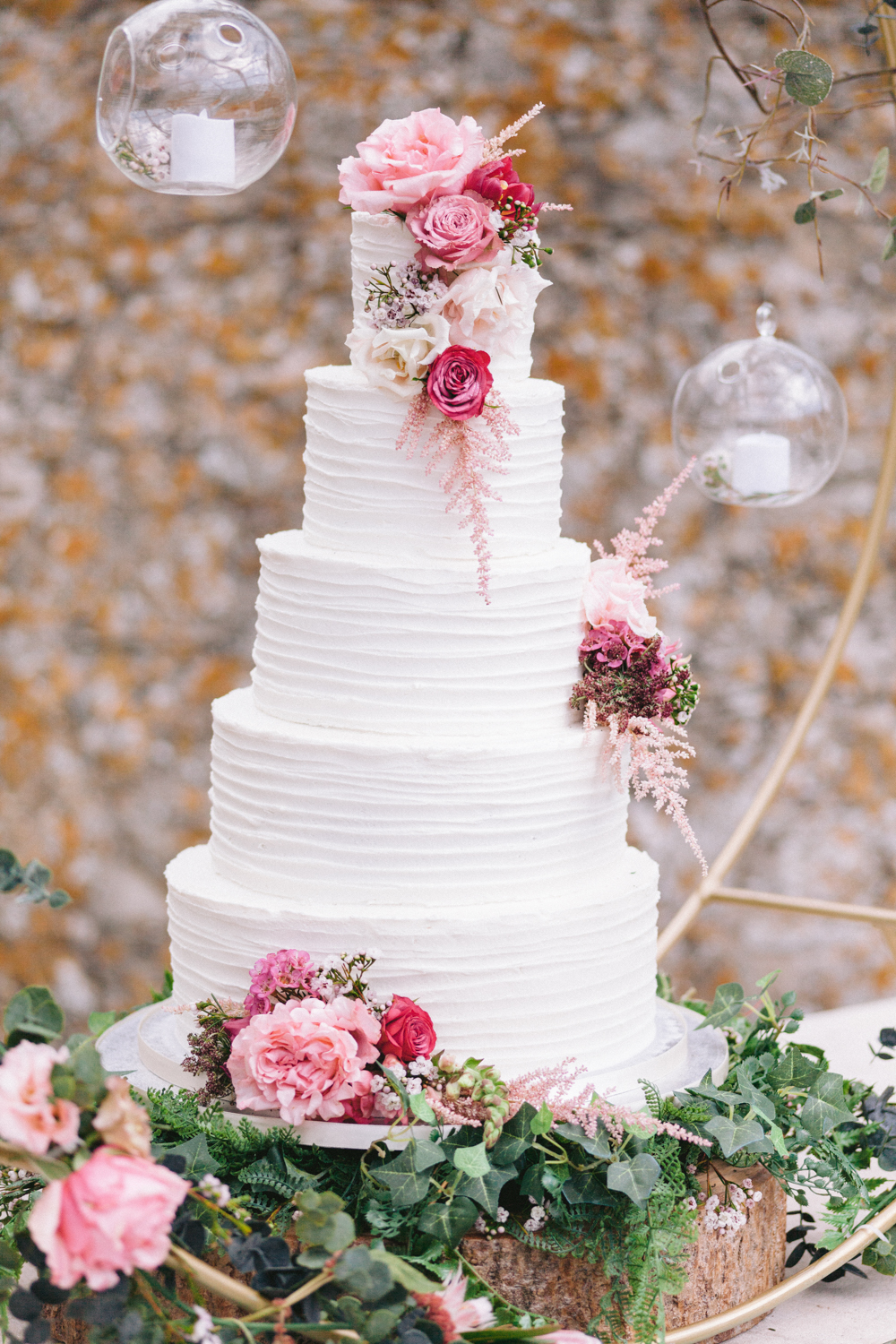 Wedding cake with lots of pink blooms 