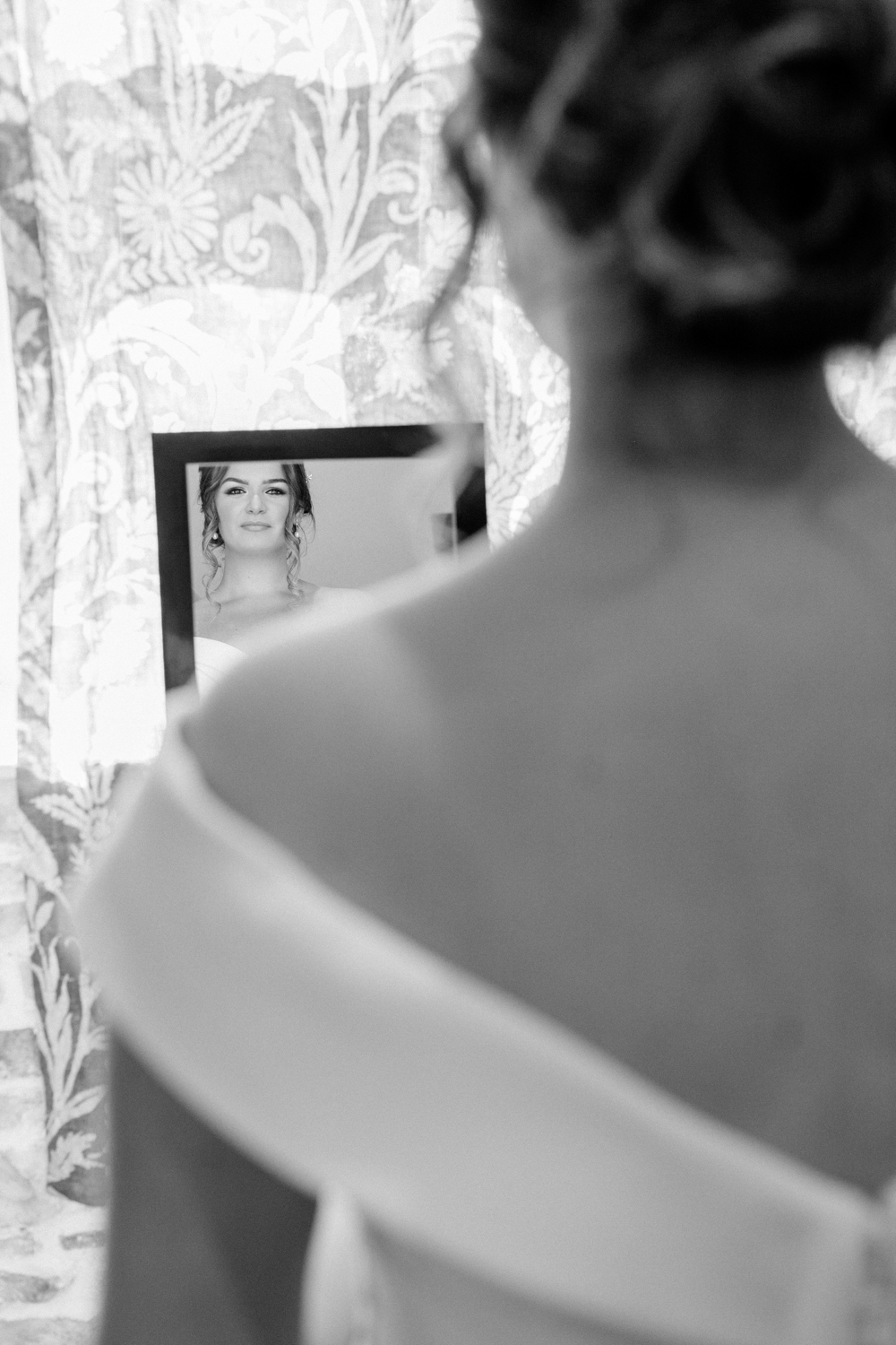 Black and white photo of bride getting ready for her micro wedding