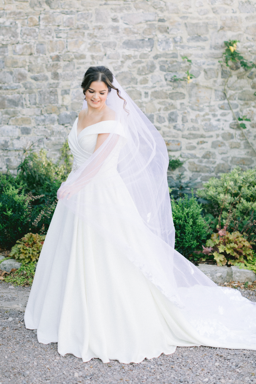 Bride standing in the grounds of Gileston Manor in her wedding dress