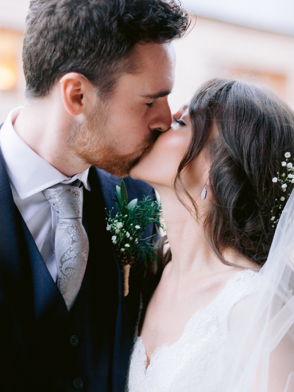 close up of Bride and Groom kissing in the rain at this romantic Cotswolds wedding