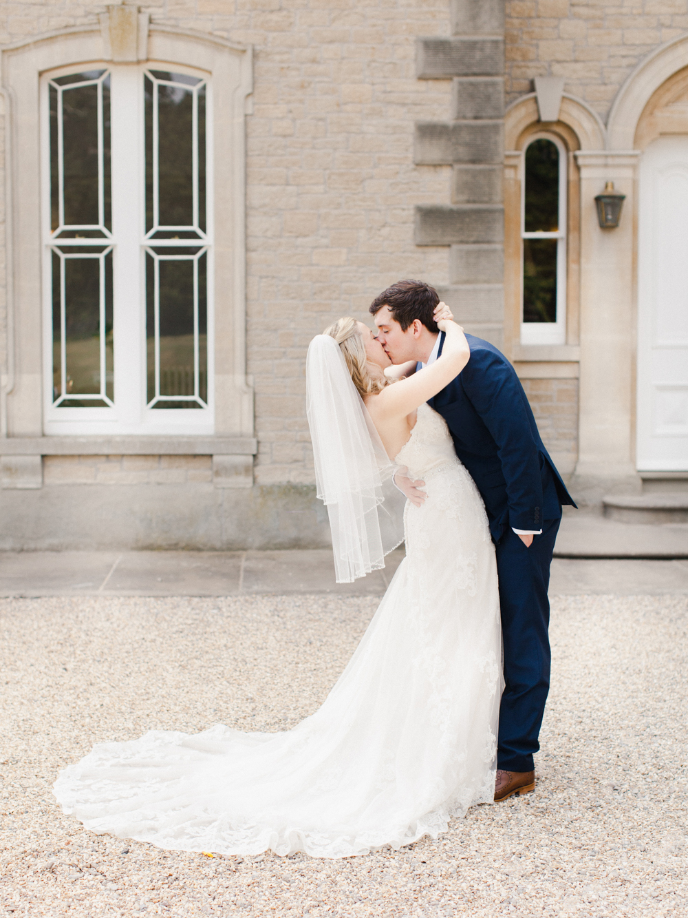 Bride and Groom kiss outside grade II listed St Tewdrics House Wedding venue