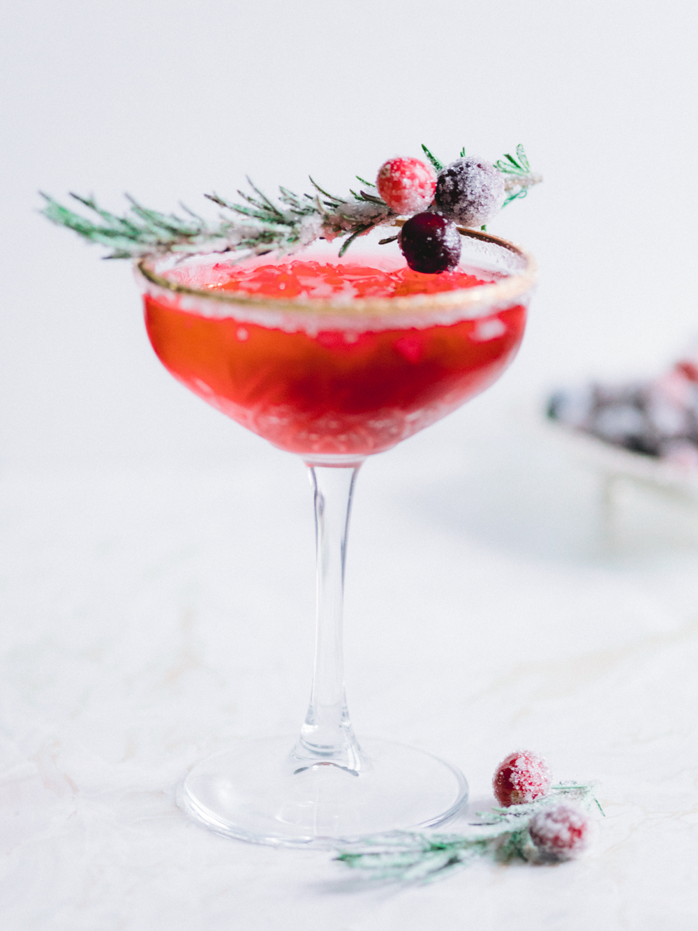 Rosemary Sugared Cranberry Cocktail in a champagne glass