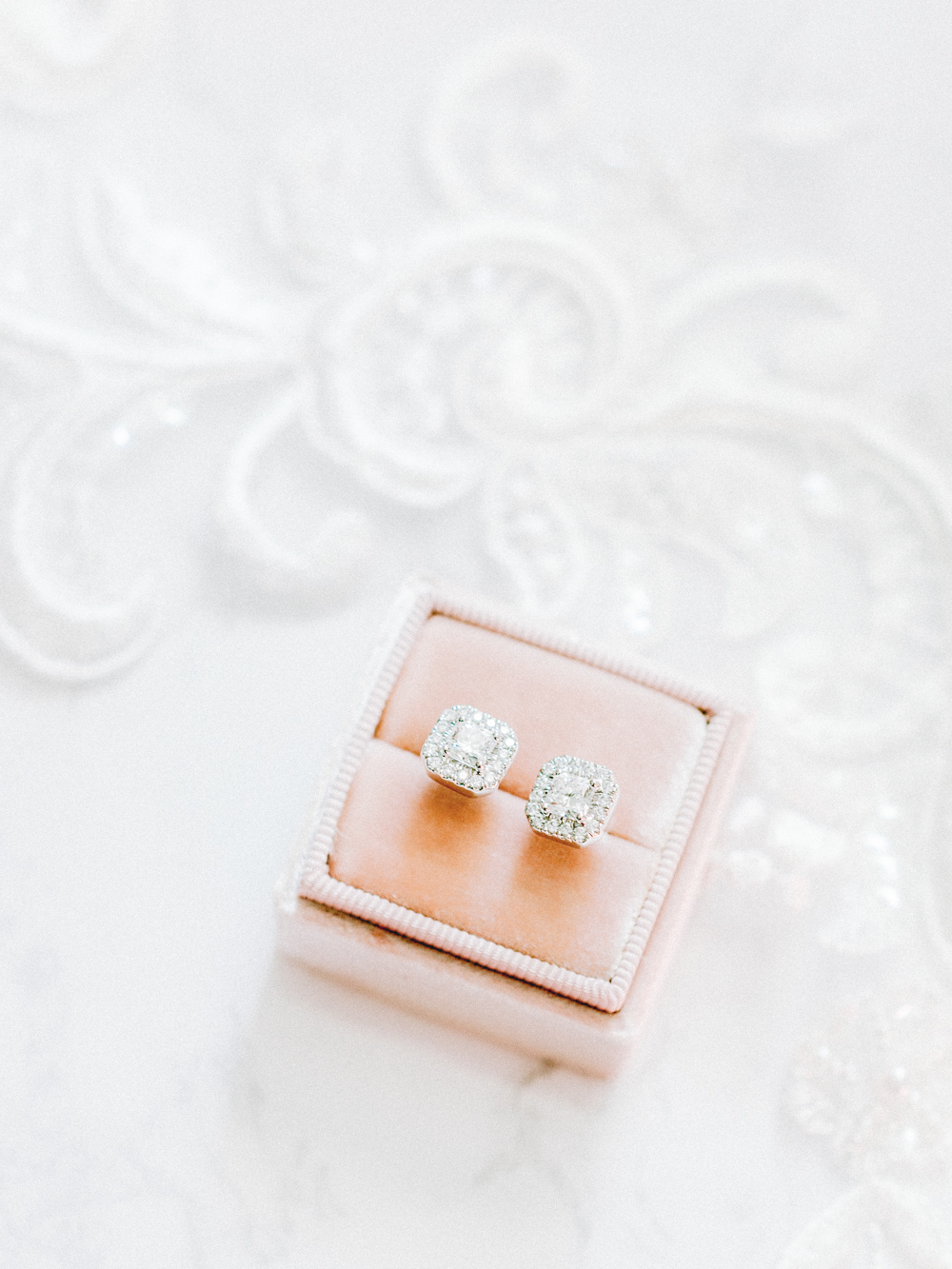 Fairytale diamond earrings with lace veil as the background