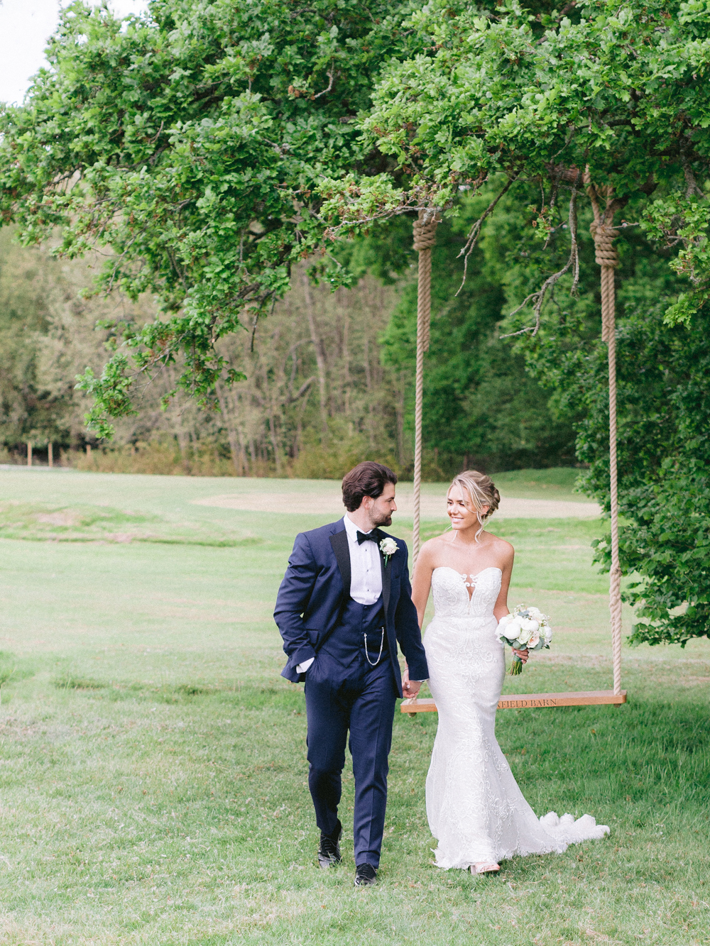 Bride and Groom stroll hand in hand around Sussex Countryside on their Elegant Wedding day