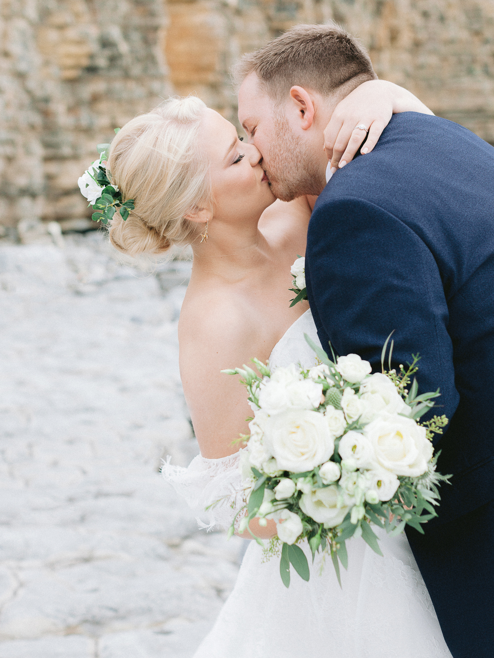 Bride and Groom kiss on the rocky beach at Llantwit Major