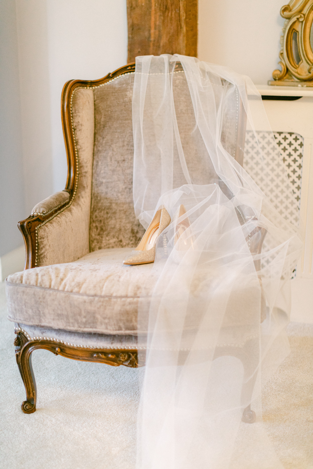Romantic veil with shoes placed on seat at Brinsop Court