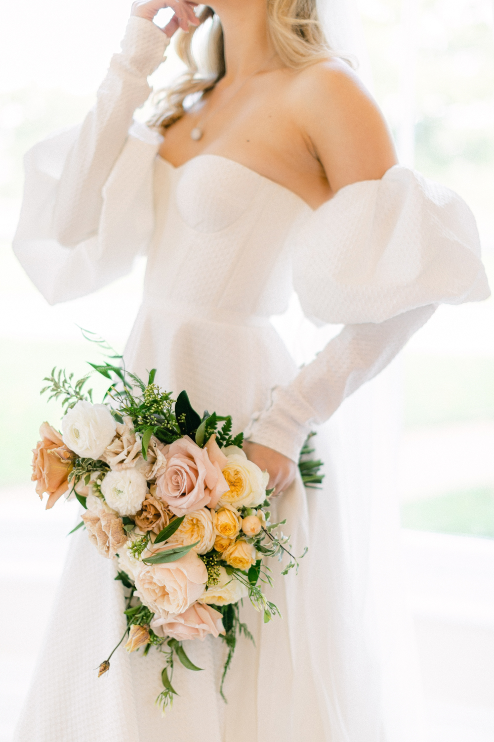 Elegant Alena Leena Bridal gown with luxury wedding flowers at Eastington Park