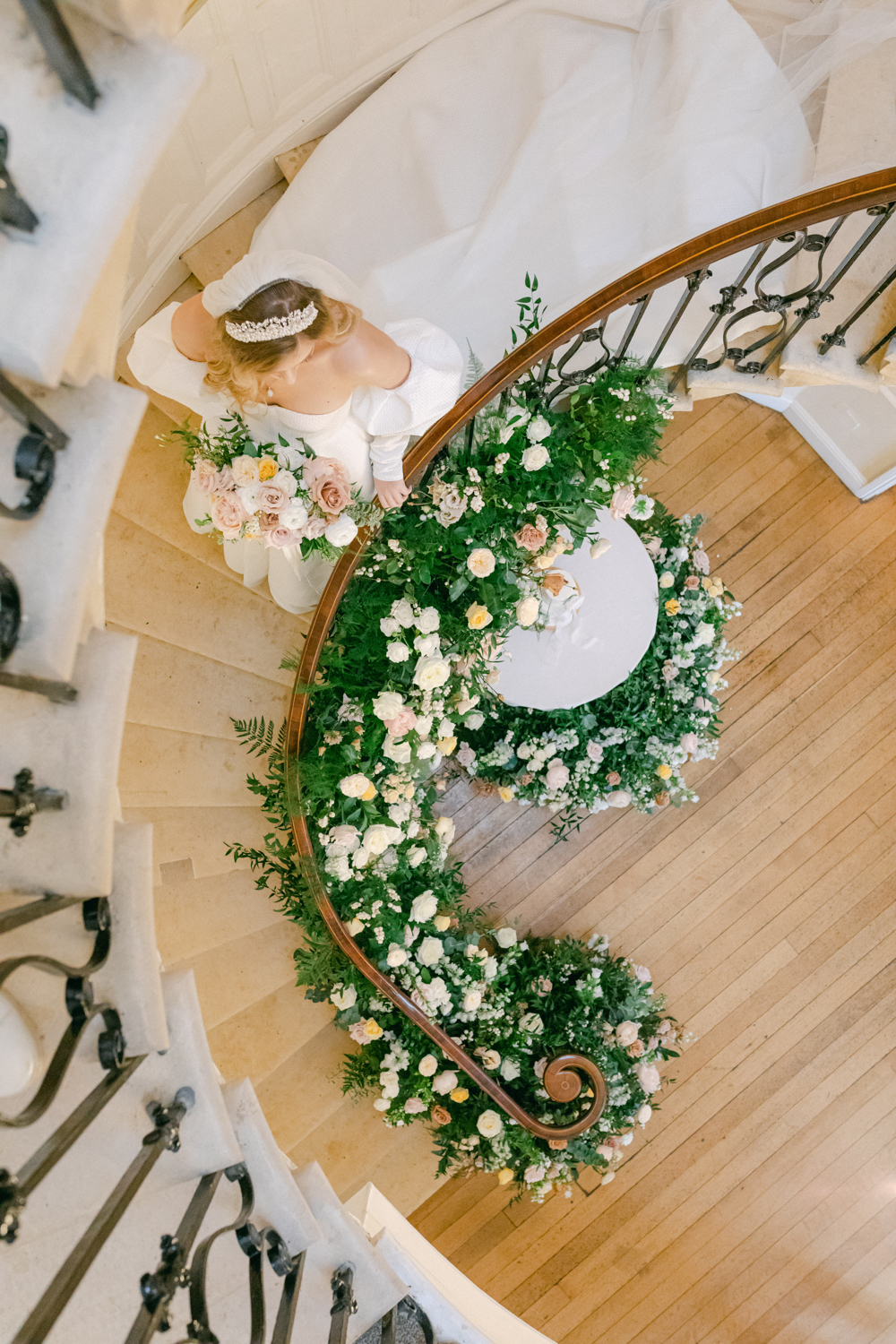 Luxury Wedding flowers adorn the whole staircase at Eastington Park from above