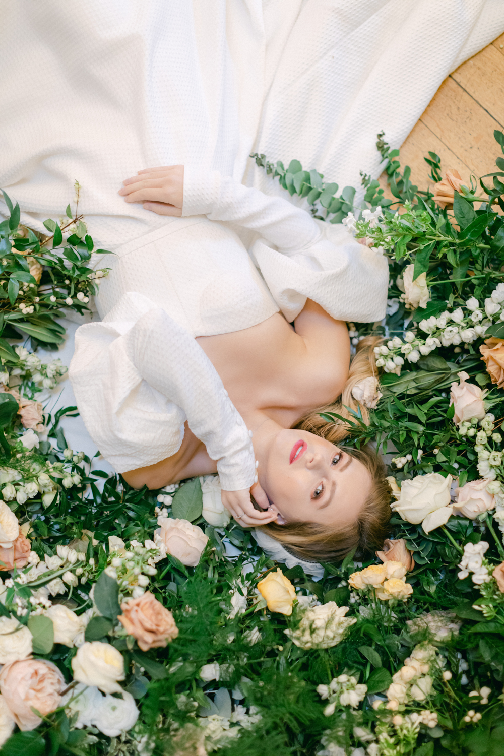 Bride laying down in Luxury Wedding flowers at Eastington Park