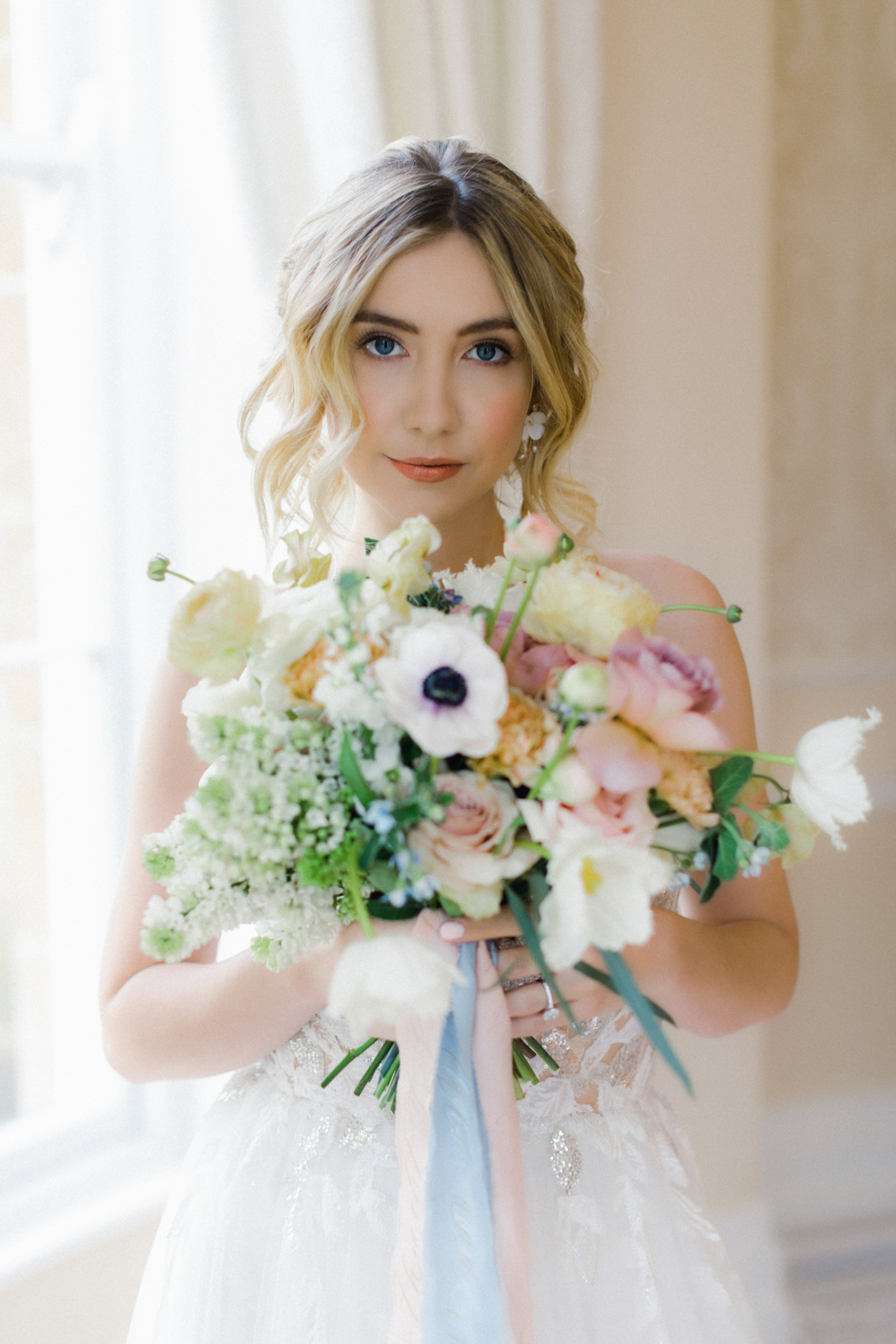 Bride with vibrant pastel wedding flowers