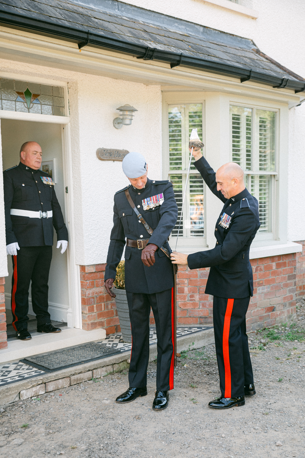 Military ceremony outside a house.