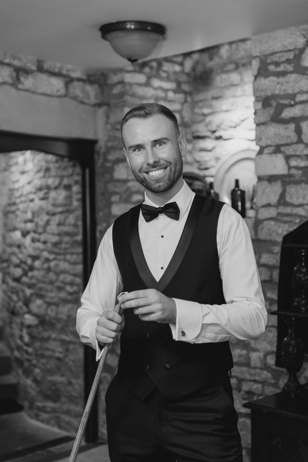 Groom playing pool at the manor house on the wedding morning
